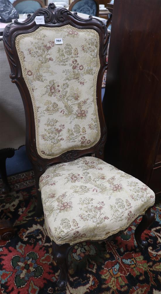 A 19th century carved mahogany framed nursing chair
